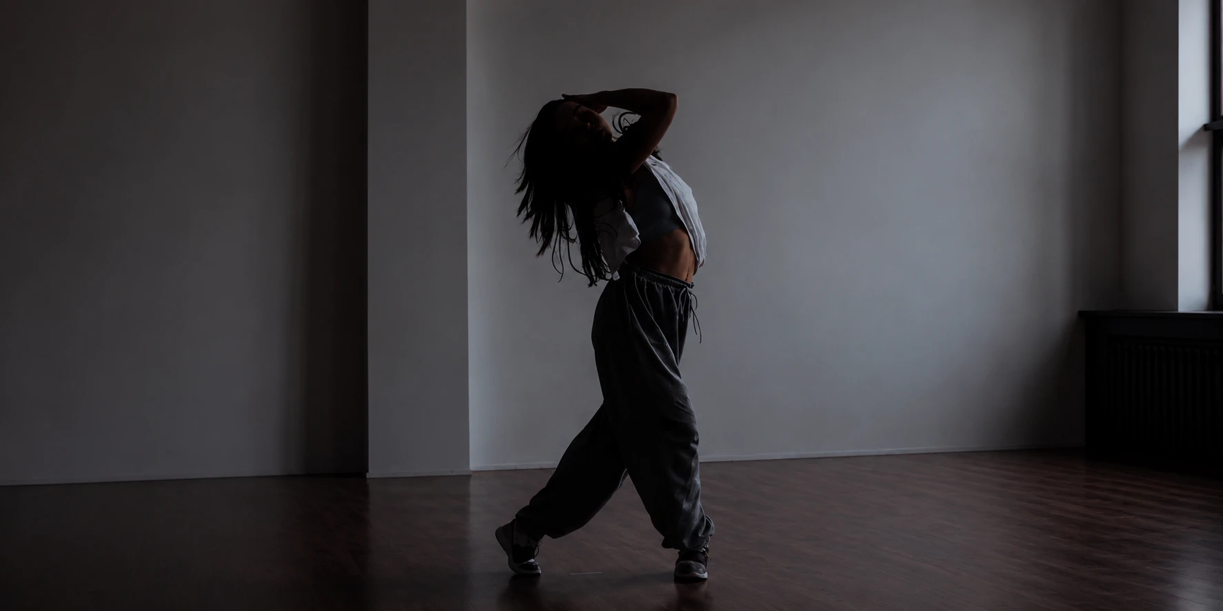 Hip-hop dancer mid-movement in a studio